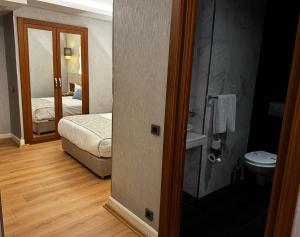 a room with a bathroom with a bed and a toilet at Style Star Hotel Cihangir in Istanbul +42 photos