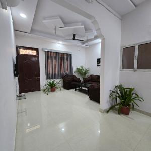 a living room with couches and a door at Leela home stay -Jabalpur - Luxury 2BHK apartment-N2 in Jabalpur