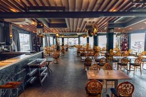 a restaurant with tables and chairs and windows at Style Star Hotel Cihangir in Istanbul