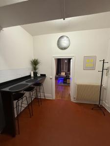 une pièce avec une table et une horloge au mur dans l'établissement le logis de la cathédrale, à Auxerre