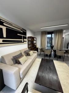 a living room with a couch and a table at Casa Amayuma - Málaga Centro Histórico in Málaga