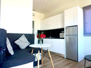 a kitchen with a couch and a table in a room at Yamina Rooftop Residence in Agia Pelagia