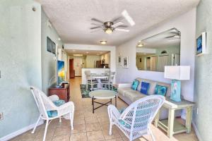 a living room with a couch and a table and chairs at Sunset Vistas 206S in St Pete Beach
