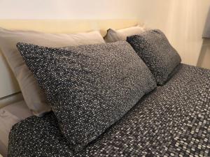 a bed with two pillows on top of it at Miralago Casa Vacanze in Villa di Chiavenna