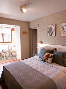 a bedroom with a large bed in a room at Domaine de la Tour de Pérès in Ayguetinte