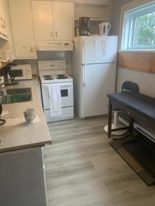 a kitchen with a white refrigerator and a stove at Room downtown 3minute walk Uottawa train station in Ottawa
