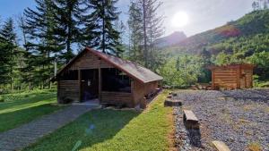 a small wooden cabin in the middle of a forest at Chata vo Vyhnanej - Terchová in Terchová