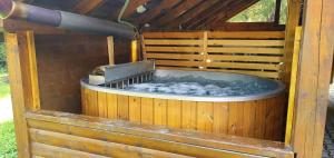 a hot tub in a wooden house with water at Chata vo Vyhnanej - Terchová in Terchová
