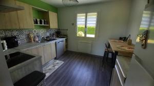 a kitchen with a sink and a counter top at Chez MONIQUE in Sainte-Marguerite +6 photos