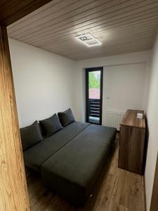 a bedroom with a large bed and a wooden table at Chata ARMA in Vrbov +37 photos