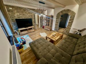 a living room with a couch and a tv at Chata ARMA in Vrbov