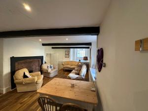 a living room with a wooden table and chairs at The Yard House in Sherborne
