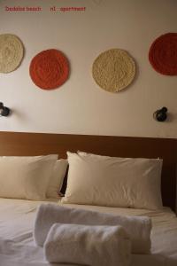 a bedroom with a bed with hats on the wall at Dedalos Beach n1 ground floor in Stalida