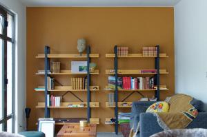 a living room with wooden shelves with books at Maison de campagne Proche de St Emilion in Montcaret