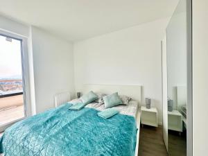 a bedroom with a bed and a large window at BudaBright 192 II FreeParking in Budapest +8 photos