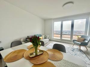 a living room with a table with a vase of flowers on it at BudaBright 192 II FreeParking in Budapest