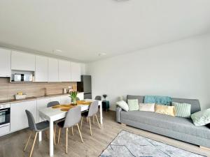 a living room with a couch and a table at BudaBright 192 II FreeParking in Budapest