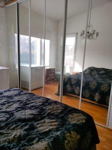a bedroom with two beds and a large mirror at 3 room apartment&terrace in Espoo