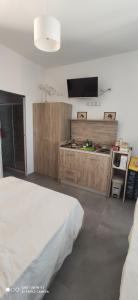 a bedroom with a bed and a flat screen tv at CASA ALLE COSTE camere con vista in Massa Marittima
