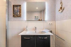a bathroom with a sink and a mirror at Doppelhaushälfte Ida in Meldorf +20 photos