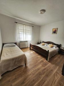 Postel nebo postele na pokoji v ubytování Apartments Plejic