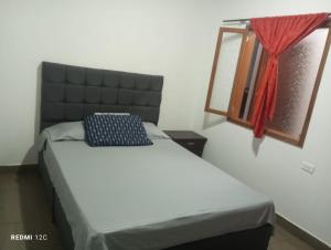 a bedroom with a bed and a mirror and a window at Hotel Talauta Resort in Talauta