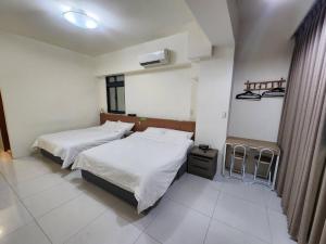 Postel nebo postele na pokoji v ubytování 馥芯莟旅棧