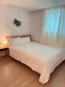 une chambre avec un grand lit blanc avec une fenêtre dans l'établissement Everland Station 5 minutes on foot, Gamsung Accommodation Everland, Caribbean Bay, Korean Folk Village, Yongin Sevens, Stay Jal Jal, à Yongin