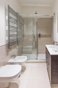 a white bathroom with two sinks and a shower at My Lodge Italy - Style and Comfort in Naples