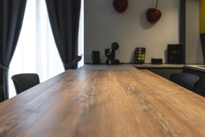 a large wooden table in a room with chairs at My Lodge Italy - Style and Comfort in Naples