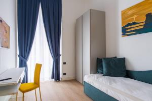 a bedroom with a bed and a desk and a desk at My Lodge Italy - Style and Comfort in Naples +32 photos