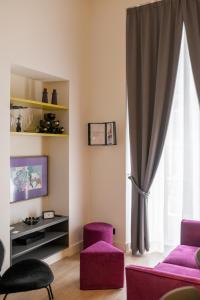 a living room with purple chairs and a window at My Lodge Italy - Style and Comfort in Naples
