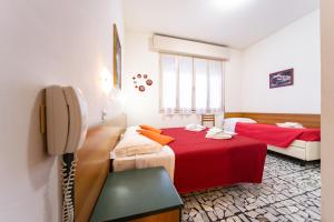 Postel nebo postele na pokoji v ubytování Hotel Cortina