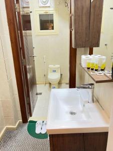 a bathroom with a sink and a toilet at غزالي سويتس ghzali suites in Al Madinah