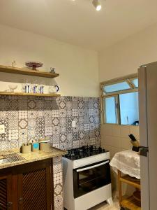 a kitchen with a stove top oven in a kitchen at Casa Vintage in Ouro Preto +76 photos