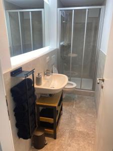 a bathroom with a sink and a shower at Appartment Kuschelecke in Kiefersfelden +12 photos