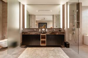 a bathroom with a sink and a mirror at Luxury Penthouse 407sqm Beachfront and private pool in Phuket Town +51 photos