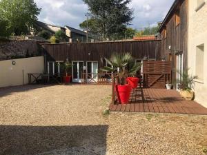 a patio with potted plants in front of a building at Appt familial avec terrasse et parking in Azay-le-Rideau