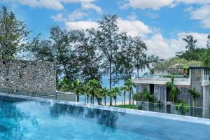 a swimming pool with a view of the ocean at Luxury Penthouse 407sqm Beachfront and private pool in Phuket Town