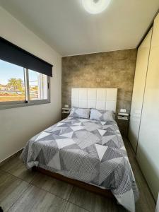 a bedroom with a large bed and a window at Starfish Home in Costa Del Silencio