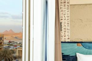 Postel nebo postele na pokoji v ubytování Sultan Pyramids View Inn