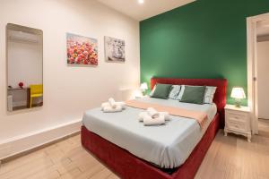 a bedroom with a bed with two towels on it at Palazzo Bicocca Rooms in Catania