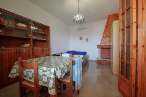 a dining room with a table and a bed at Le conchiglie relax in spiaggia in Lido Conchiglie +13 photos