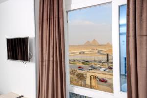 TV a/nebo společenská místnost v ubytování Sultan Pyramids View Inn
