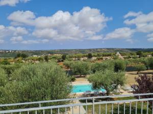 a view from the balcony of a villa with a swimming pool at TRULLO MALVISCHI - Privacy & Pool in Alberobello