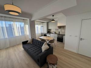 a living room with a couch and a table at The Crow Ajuda Apartment I in Lisbon