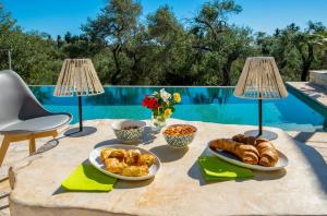 a table with bread and other foods on it at Island Breeze Villa in Bogdanátika +32 photos