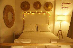 a bedroom with a bed with lights on it at Dedalos Beach n6 sea view in Stalís