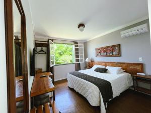 Ένα ή περισσότερα κρεβάτια σε δωμάτιο στο Pousada Villa Allegra +60 φωτογραφίες