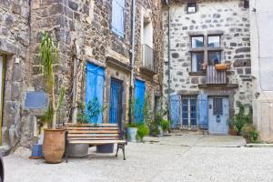 a wooden bench sitting in front of a building at Chez Régine in Agde